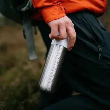 Dopper insulated thermos bottle with stainless steel body and black screw-on lid, designed for hot and cold beverages.