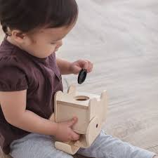 PlanToys elephant bank made of eco-friendly wood, featuring a playful elephant design and coin slot for saving money.