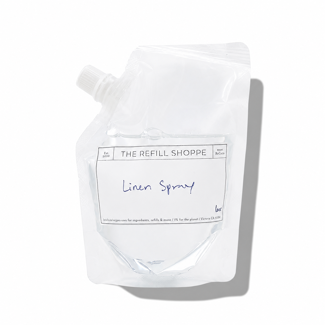 Linen spray by The Refill Shoppe with a clear bottle and spray nozzle, designed for freshening fabrics and linens.