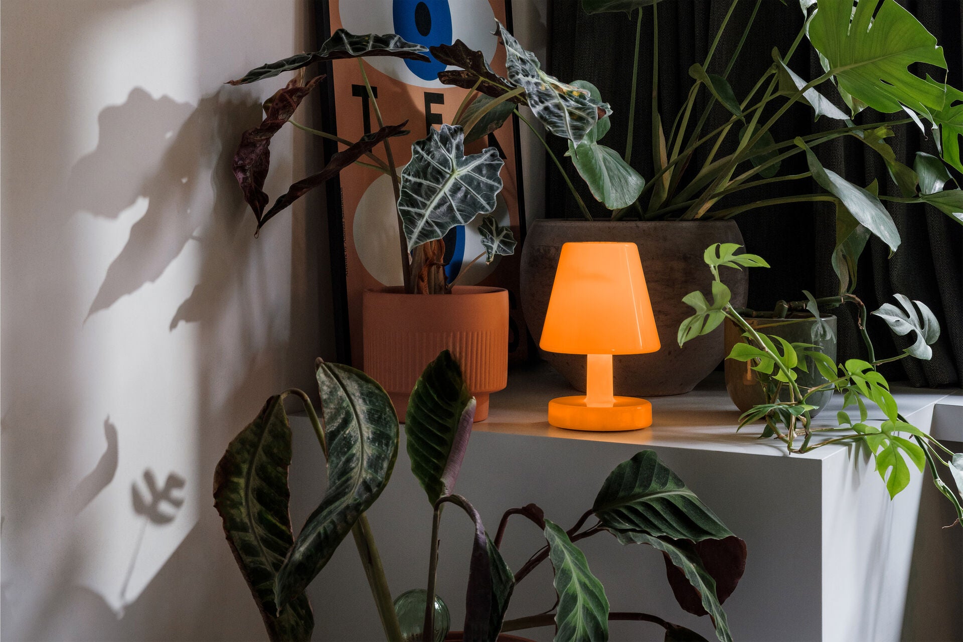 Sunny orange Fatboy Edison The Ambiance lighting with a modern design, creating a warm, cozy atmosphere.