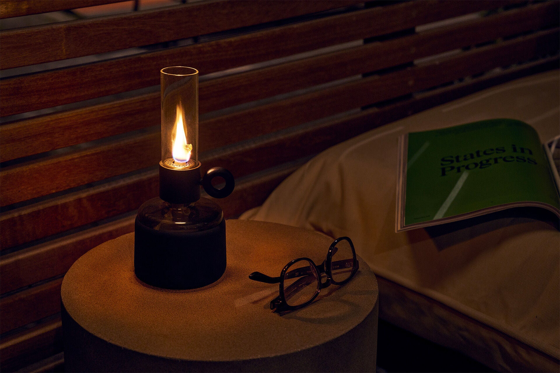 Black Flamtastique XS Fatboy lighting fixture with a sleek, modern design, shown glowing in an ambiance setting.