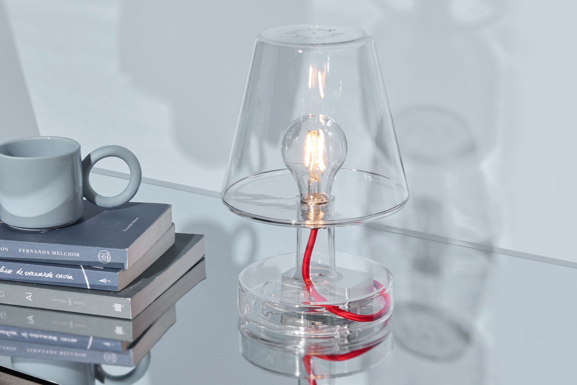 Transloetje transparent lamp by Fatboy, modern lighting with a clear glass shade and minimalist design, on a white background.