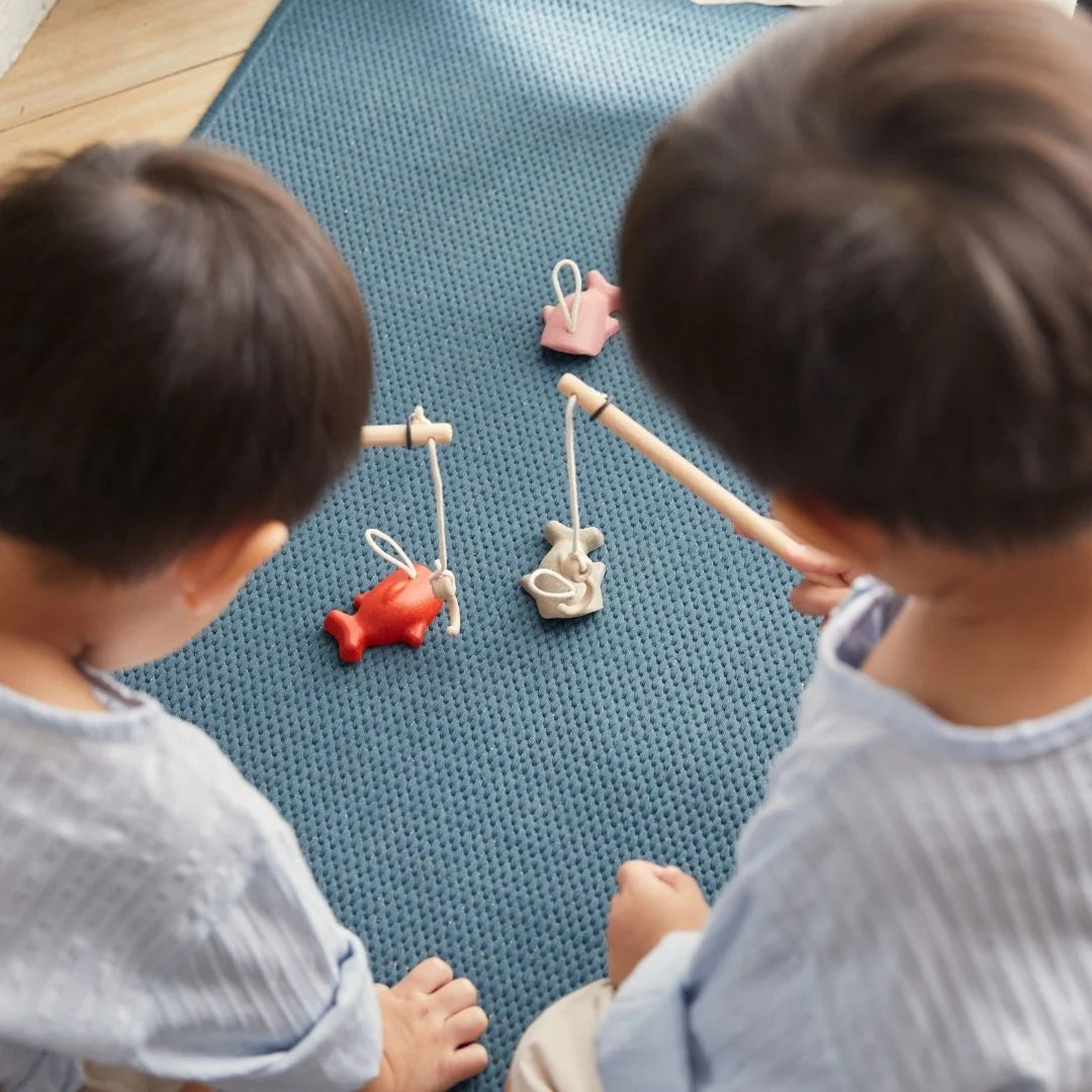 PlanToys fishing game with wooden fishing rods and colorful fish toys for kids' fun and imaginative play.